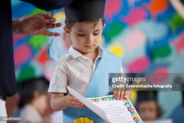 photograph of a little boy on the day of his graduation from nursery school - summer school stock pictures, royalty-free photos & images