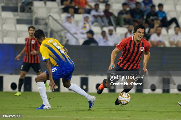 Sebastián Soria is tackled by Almahdi Ali Mukhtar during Qatar Stars League match between Al Rayyan and Al Gharafa at the Jassim Bin Hamad Stadium,...