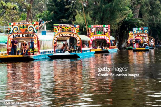 Gaily decorated boats fill the canal at Xochimilco floating gardens, Mexico City, Mexico.