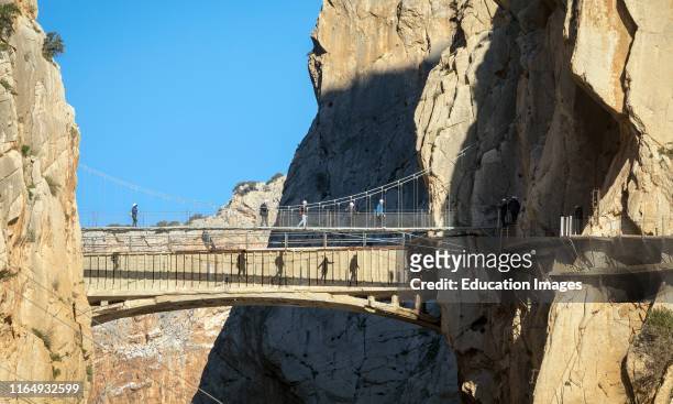 Visitors on the El Caminito del Rey or The Kingâs Walkway The walkway is built into the side of the gorge of El Chorro in the Desfiladero De Los...