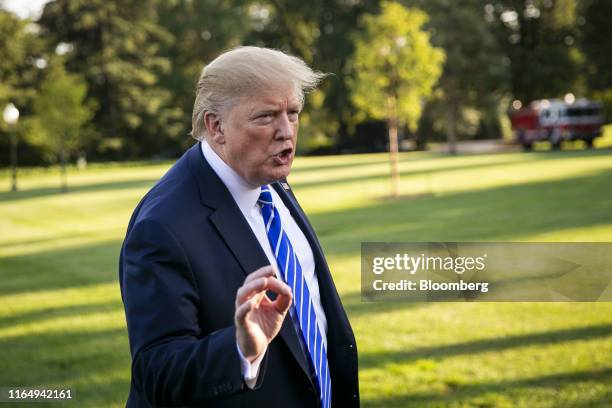 President Donald Trump speaks to members of the media before boarding Marine One on the South Lawn of the White House in Washington, D.C., U.S., on...