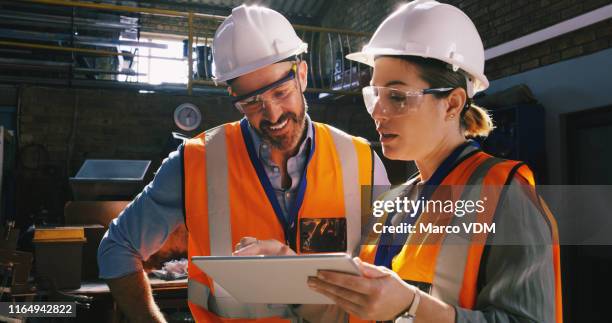 connected to the current happenings in the field of engineering - factory engineer woman imagens e fotografias de stock