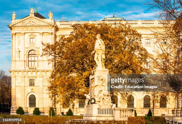 Mozart statue at Neue Burg building part of the Hofburg palace complex seen from Burggarten Vienna, Austria.