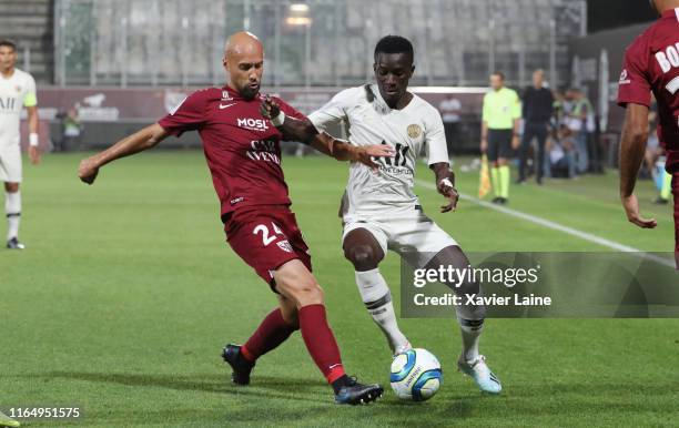 Idrissa Gueye of Paris Saint-Germain in action with Renaud Cohade of FC Metz during the Ligue 1 match between FC Metz and Paris Saint-Germain at...