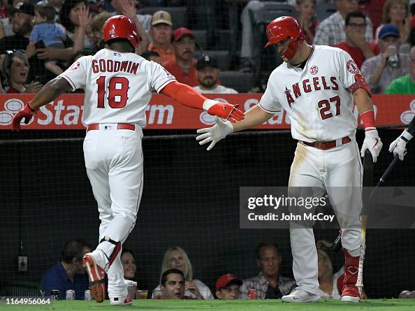 Brian Goodwin of the Los Angeles Angels is congratulated by Mike ...