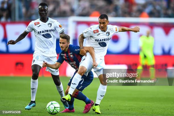 Le Havre's midfielder Pape Gueye, Caens midfielder Jan Repas and Le Havre's defender Umut Meras during the French Ligue 2 football match between...