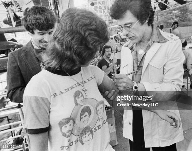 Sharon Ruta of Brooklyn gets her Four Seasons tee shirt signed by musician Frankie Valli before Valli's rehearsal for his concert at Wollman Rink in...