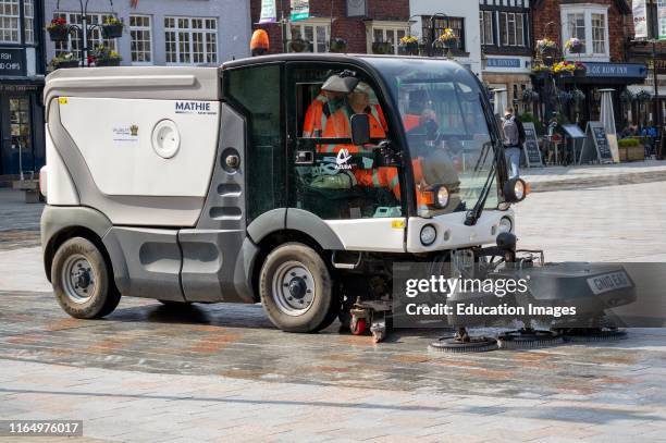 Salisbury, Wiltshire, England, UK, A mechanical street sweeper operative and machine cleaning the Market Square area of the city center.