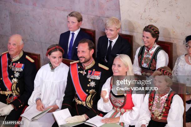 Princess Ingrid Alexandra sits next to Queen Sonja, Crown Princess Mette-Marit, Crown Prince Haakon, Princess Ingrid Alexandra, King Harald V and...