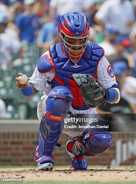 Martin Maldonado of the Chicago Cubs prepares to throw back a warm-up pitch against the San Diego Padres at Wrigley Field on July 19, 2019 in...