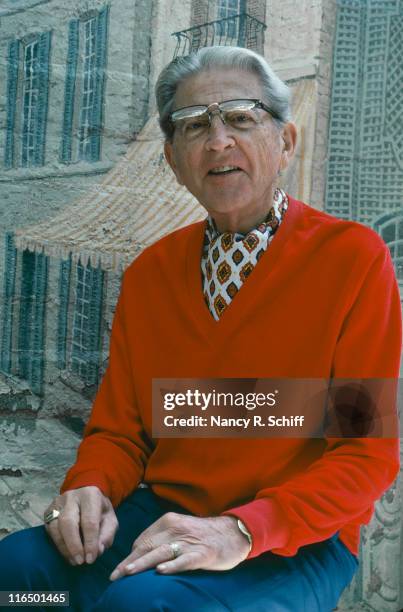 American composer and lyricist Meredith Willson wearing a red v-neck jumper and cravat, 1982.