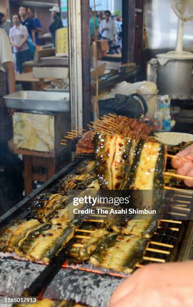 Staff grills eels on July 27, 2019 in Urayasu, Chiba, Japan. It is said that people eat eel on the Doyo-no-Ushi-no-Hi, July 27 this year, day of the...