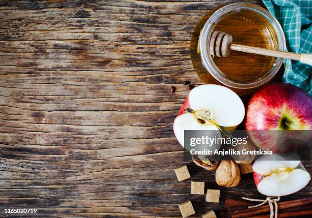 autumn background with apples, honey, cinnamon, walnut and brown sugar on wooden background with copy space. - rosh hashanah stock pictures, royalty-free photos & images