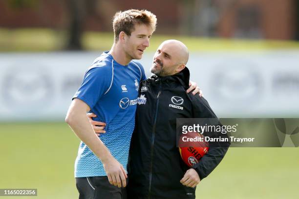 Rhyce Shaw, interim Senior Coach of the Kangaroos shaw a laugh with Sam Durdin during a North Melbourne Kangaroos AFL training session at Arden...