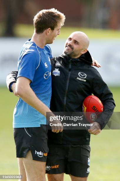 Rhyce Shaw, interim Senior Coach of the Kangaroos shaw a laugh with Sam Durdin during a North Melbourne Kangaroos AFL training session at Arden...