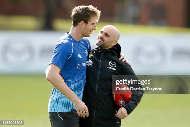 Rhyce Shaw, interim Senior Coach of the Kangaroos shares a laugh with Sam Durdin during a North Melbourne Kangaroos AFL training session at Arden...