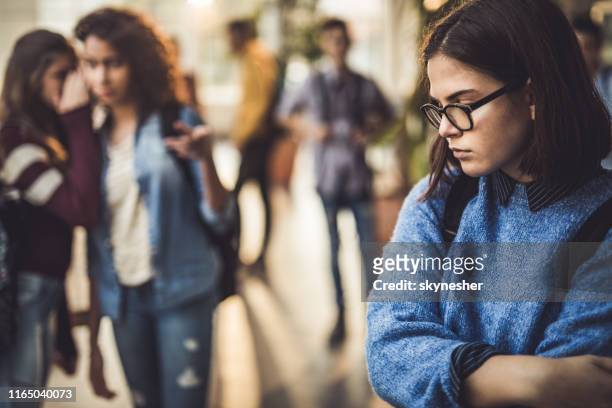 sad high school student feeling lonely in a hallway. - stereotypical stock pictures, royalty-free photos & images
