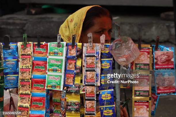 Woman selling pan masala waits for the customers in New Delhi on 31 August 2018