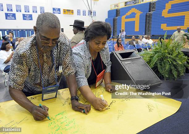 Former Department of Agriculture rural development official Shirley Sherrod, right, and Bob Mants sign the names of past leaders while attending the...