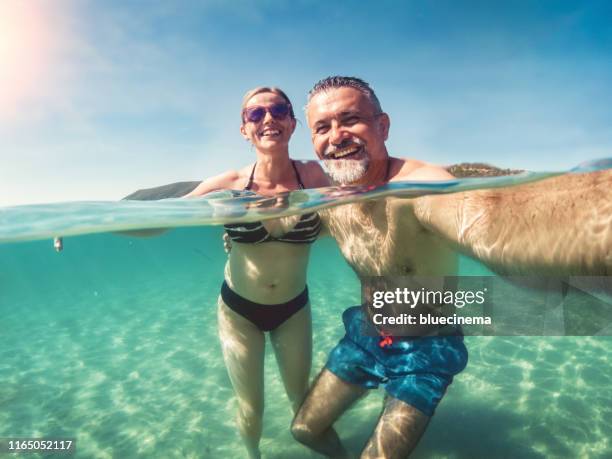 vacation selfie of a mature couple - mature adult couples stock pictures, royalty-free photos & images