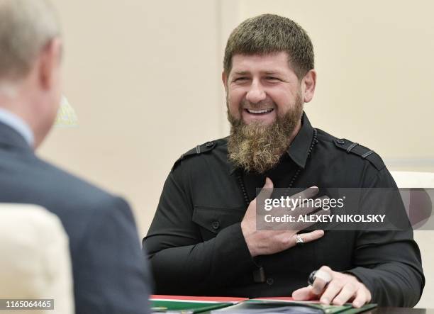 Head of the Chechen Republic Ramzan Kadyrov speaks with Russian President Vladimir Putin at the Novo-Ogaryovo state residence outside Moscow, on...