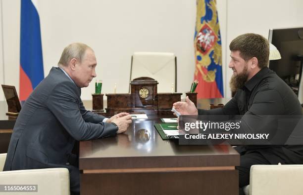 Head of the Chechen Republic Ramzan Kadyrov speaks with Russian President Vladimir Putin at the Novo-Ogaryovo state residence outside Moscow, on...