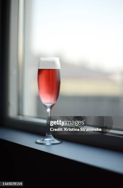 a glass of rose wine in a windowsill - window sill stock pictures, royalty-free photos & images