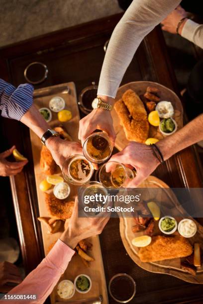 cheers to friendship - fish and chips stock pictures, royalty-free photos & images