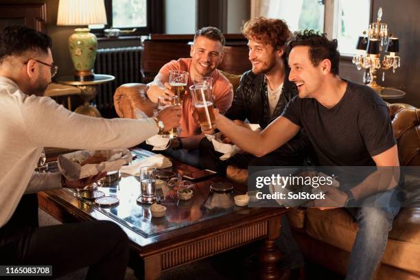 celebratory toast at the pub - pub mates stock pictures, royalty-free photos & images