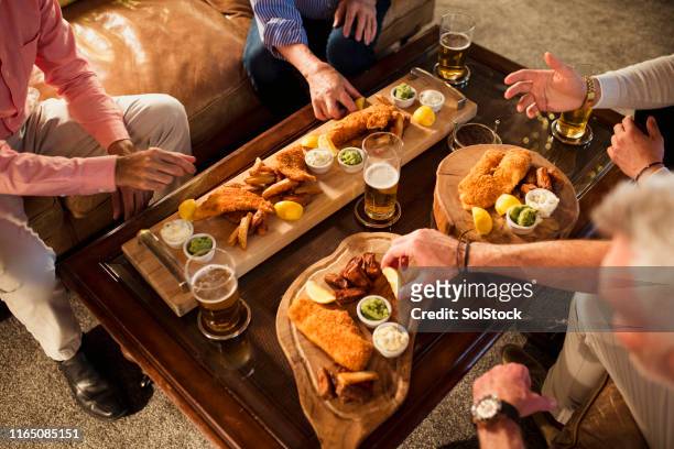 bonding over fish and chips - pub food stock pictures, royalty-free photos & images