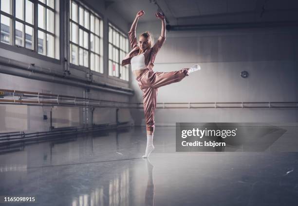 young ballerina posing in dance studio. - dance studio stock pictures, royalty-free photos & images