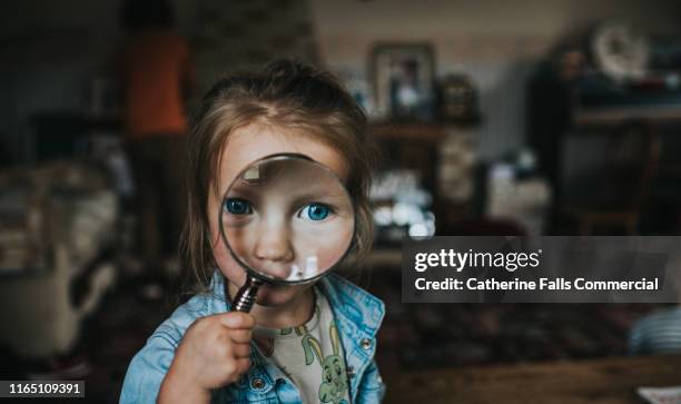 magnifying glass - kid peeking stock pictures, royalty-free photos & images