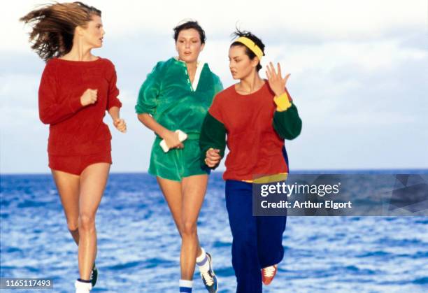 Vogue, April 01, 1977 - Three models running on the beach near The Spa at Palm-Aire, Florida. From left to right: Model Christie Brinkley wears Cathy...