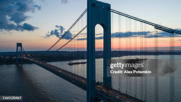 traffic on verrazano-narrows bridge at sunset. aerial drone photo - verrazano narrows bridge stock pictures, royalty-free photos & images