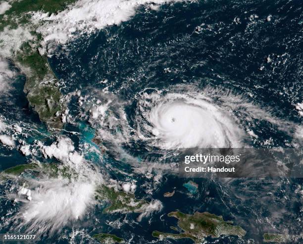 In this NOAA GOES-East satellite handout image, Hurricane Dorian, now a Cat. 4 storm, tracks towards the Florida coast taken at 13:40Z August 31,...