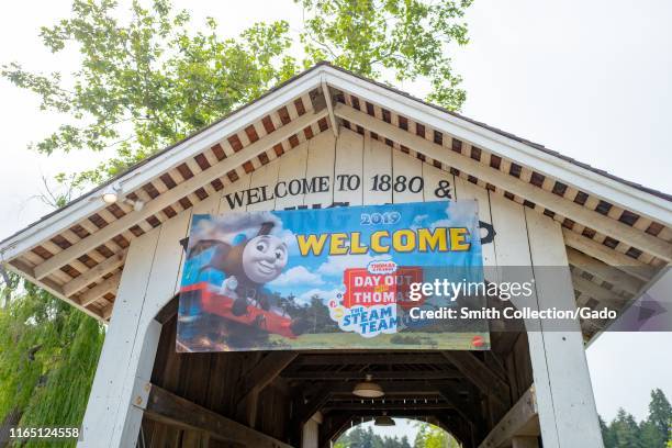 Low-angle view of the Roaring Camp covered bridge, originally construction in 1964 in Felton, California, with banner for Day Out With Thomas...