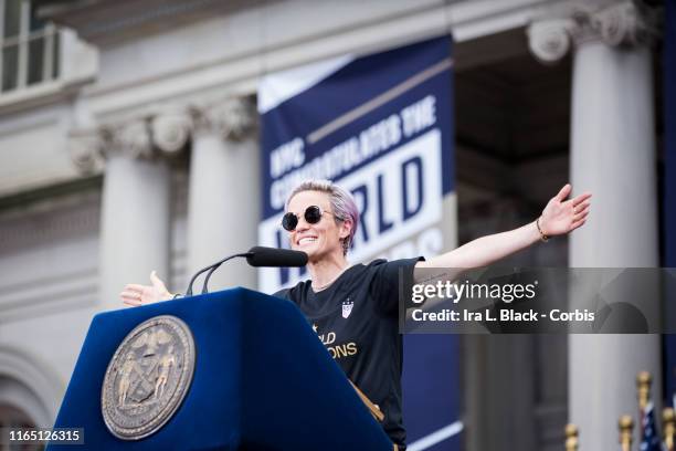 Megan Rapinoe of United States smiles and holds out her hands as she addresses the crowd during the ceremony on the steps of City Hall after the...