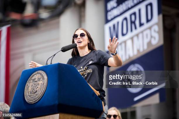 Alex Morgan of United States addresses the crowd during the ceremony on the steps of City Hall after the ticker tape parade down Broadway and through...