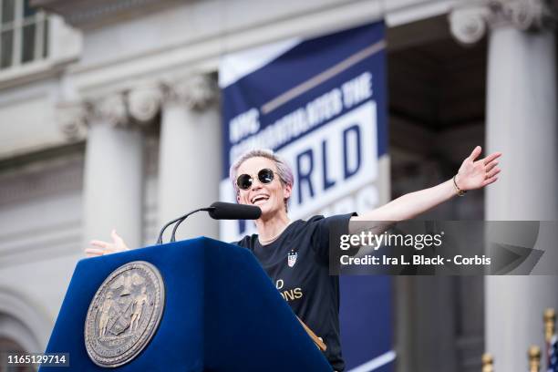 Megan Rapinoe of United States smiles and holds out her hands as she addresses the crowd during the ceremony on the steps of City Hall after the...