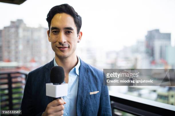 mixed race male tv reporter - asian journalist stock pictures, royalty-free photos & images