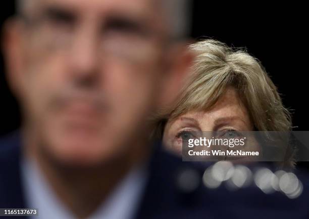 As his wife Laura looks on, U.S. Air Force Gen. John E. Hyten testifies before the Senate Armed Services Committee on his appointment as the next...