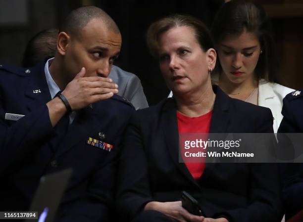 Air Force Col. Kathryn Spletstoser , confers with a colleague as U.S. Air Force Gen. John E. Hyten testifies before the Senate Armed Services...