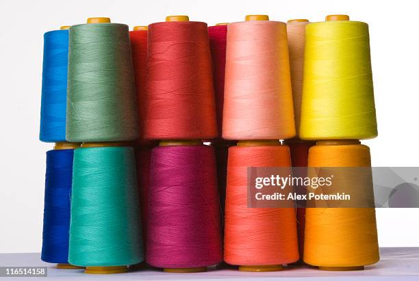 a pile of multicolored spools of sewing thread - spool stock pictures, royalty-free photos & images