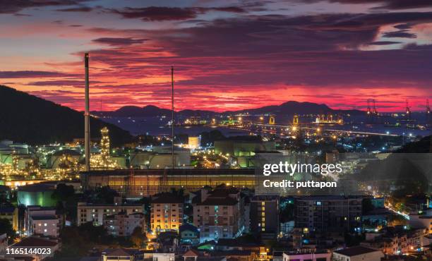 aerial view of and oil refinery at sunset time and container ship in import export and business logistic, shipping cargo to harbor, international transportation, business logistics concept - saudi arabia city stockfoto's en -beelden