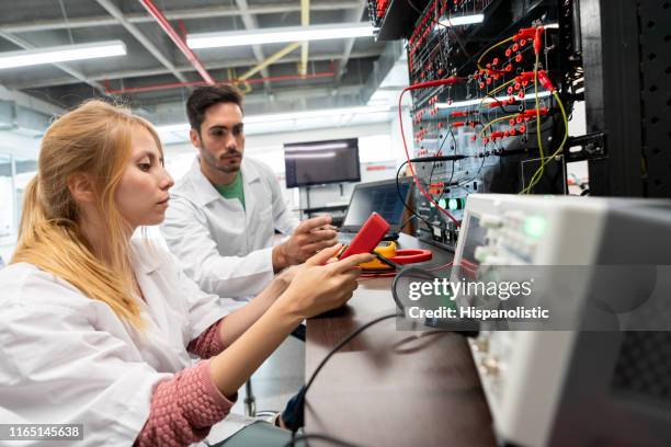 couple engineer students working on a project with electrical equipment - engeneer student electronics stock pictures, royalty-free photos & images