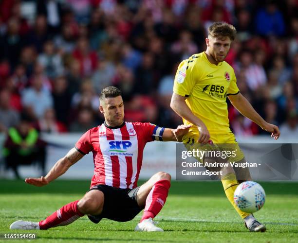 Fleetwood Town's Ched Evans is tackled by Lincoln City's Jason Shackell during the Sky Bet League One match between Lincoln City and Fleetwood Town...