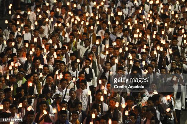 Muslims in Indonesia take part in an electric torch parade during the celebration of the Islamic New Year's Eve 1441 Hijri on M.H. Thamrin Street...