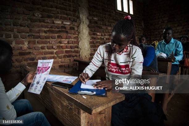 Teachers attend an awareness session organized by the Red Cross, two days before the start of the school year, in Beni, northeastern Democratic...