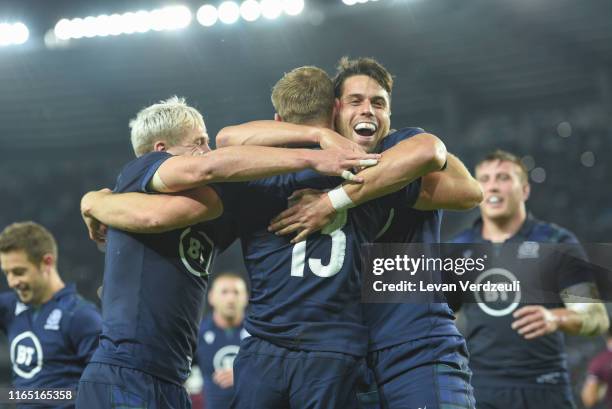 Rory Hutchinson of Scotland celebrates with his team-mates after scoring a try during the rugby international match between Georgia and Scotland at...