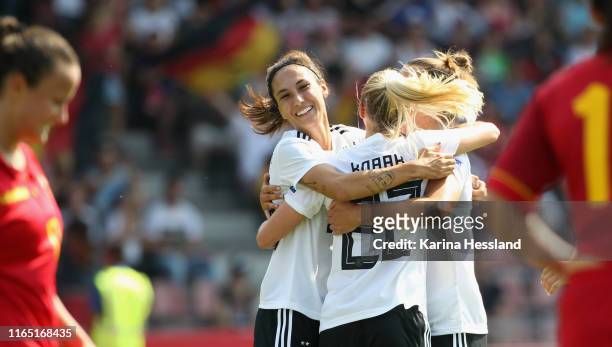 Turid Knaak of Germany celebrates the eighth goal with teammates during the Women's EM Qualification match between Germany and Montenegro at...